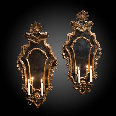 A pair of gilded wood mirrors, decoration of grotesques, flowers and palm-leaf motif, 2 arms of light, Venice, Italy, early 18th century (94 cm high, 45 cm wide) (37 in. high, 18 in. wide)