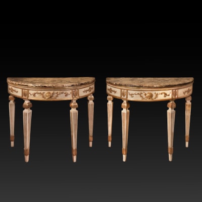 An important pair of ivory lacquered and gilded wood demi-lune consoles, with a beautiful 