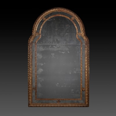An important gilded and carved wood mirror, 