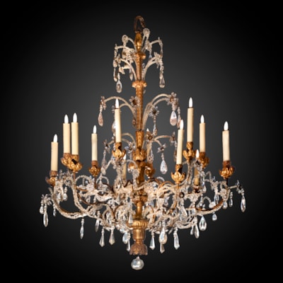 An important gilded and carved wood chandelier, 12 arms of light on 2 levels, crystal drops and glass beads, Genoa, Italy, late 18th century (130 cm high, 100 cm diameter) (51 in. high, 39 in. diameter)