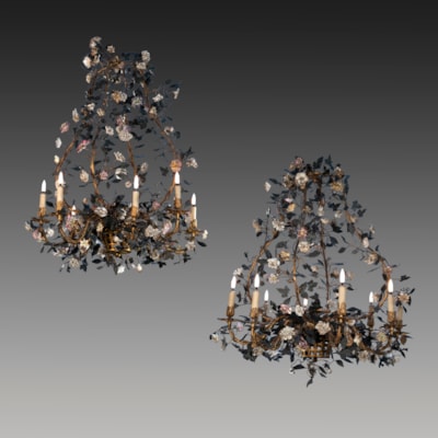 A pair of painted and gilded iron and brass chandeliers, 8 arms of light, from a basket a decoration with leaves and fine porcelain flowers, north of Italy, early 19th century (85 cm high, 70 cm diameter) (33 in. high, 28 in. diameter) 